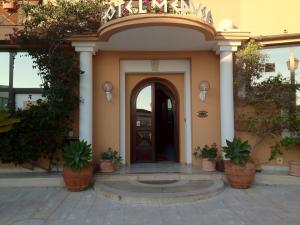a entry to a building with a door and potted plants at Hotel Medusa in Lampedusa