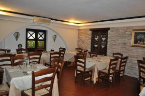 a dining room with tables and chairs and a brick wall at Hotel Duca Di Calabria in Serra San Bruno