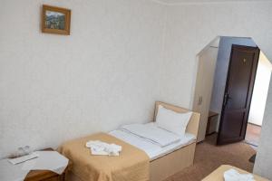 a room with two beds with towels on them at Motel Don Tomaso in Vaslui