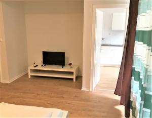 a living room with a flat screen tv on a table at Ferienwohnung Neuss in Neuss