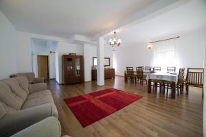 a living room with a couch and a table at Agropensiunea Cetatuia in Luncaviţa