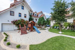 a playground in the backyard of a house at Bałtyk Resort in Rewal