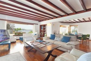 a living room with a couch and a table at Ses Gerres Beach House in Illetas