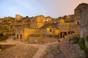 an old building with a bunch of statues on top of it at Basiliani Hotel in Matera