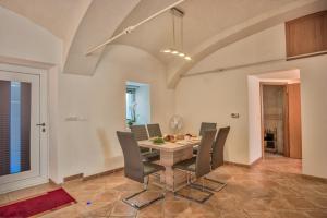 a dining room with a table and chairs at Apartment Pod velbi in Ljubljana