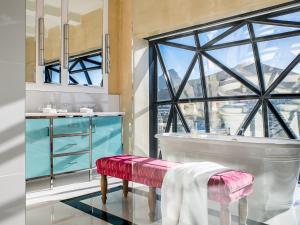 a bathroom with a tub and a window at The Silo Hotel in Cape Town