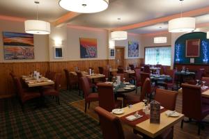 a dining room with wooden tables and chairs at Rob Roy Hotel in Aberfoyle