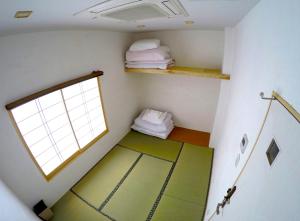 Postel nebo postele na pokoji v ubytování Hiroshima Hostel EN