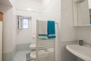a white bathroom with a toilet and a sink at Casa Beverini in La Spezia +16 photos