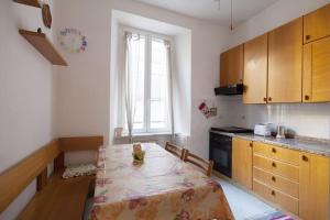 a kitchen with a table and a kitchen with a window at Casa Beverini in La Spezia