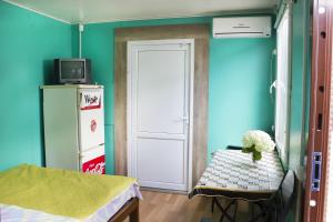 a room with a door and a table with flowers on it at Dacha v Odesse in Odesa