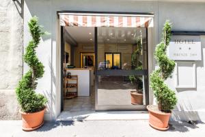 a store entrance with potted plants in front of it at Youth Firenze 2000 in Florence
