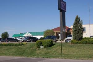 a parking lot with cars parked in front of a building at Motel 6 Hastings NE in Hastings