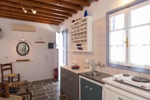 a kitchen with a sink and a window at Aris & Maria Houses in Kastron +72 photos