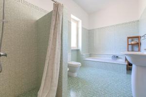 a bathroom with a toilet and a sink and a shower at Villa Merienne by BarbarHouse in Leuca