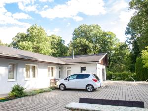 a white car parked in front of a house at Privat HOTOS in Liptovský Mikuláš