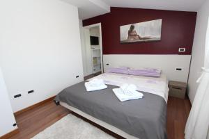 a bedroom with a bed with two towels on it at Apartments Tanja in Rovinj