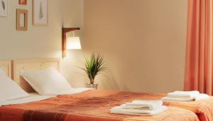 a bedroom with two beds with towels on them at Vila Dunavski Raj in Golubac
