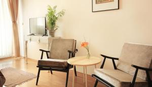 a living room with two chairs and a table at Vila Dunavski Raj in Golubac