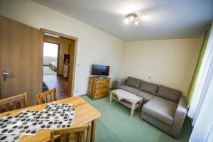 a living room with a couch and a table at Privat Galfy in Smokovce