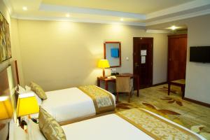 Ένα ή περισσότερα κρεβάτια σε δωμάτιο στο Jupiter International Hotel - Bole