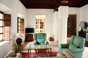 a living room with two chairs and a coffee table at Riyad El Cadi in Marrakesh