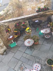 an outdoor patio with tables and chairs and plants at Bertram's in Warkworth