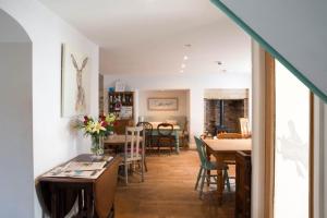 a living room with a table and a dining room at Bertram's in Warkworth