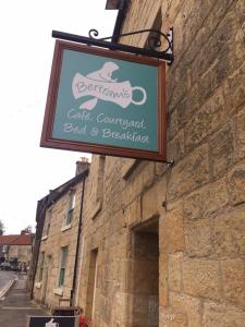 a sign hanging on the side of a building at Bertram's in Warkworth