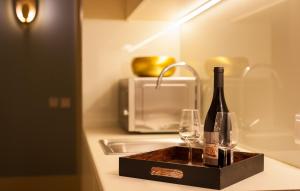 a bottle of wine sitting on top of a counter at Oca Flores Hotel Boutique in Porto