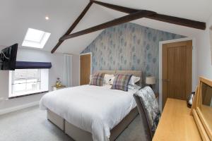 a bedroom with a bed and a tv in it at Bertram's in Warkworth