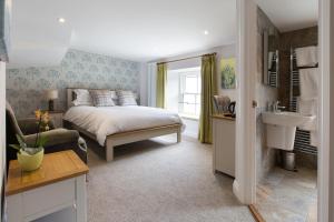 a bedroom with a bed and a sink in it at Bertram's in Warkworth