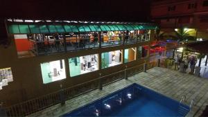 a building with a swimming pool in front of it at Pousada H&D in Angra dos Reis