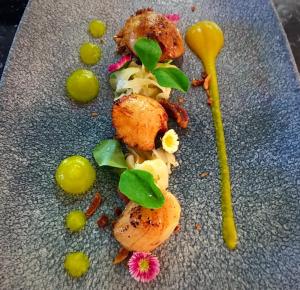 a plate of food with vegetables and a spoon at The Bath Arms Hotel in Cheddar