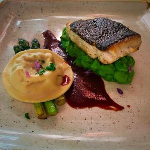 a plate of food with a sandwich and sauce at The Bath Arms Hotel in Cheddar