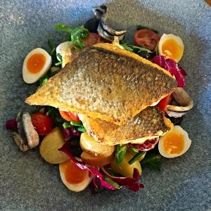 a sandwich on a plate with vegetables and eggs at The Bath Arms Hotel in Cheddar