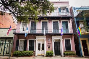 a pink building with flags in front of it at Lamothe House Hotel a French Quarter Guest Houses Property in New Orleans