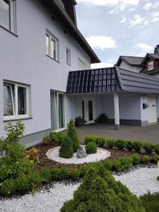 a house with a garden in front of it at Luba in Hillesheim