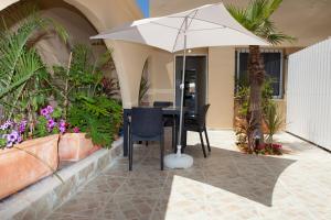 a table with an umbrella in a courtyard at Geula Suites BY RAPHAEL HOTELS in Tel Aviv
