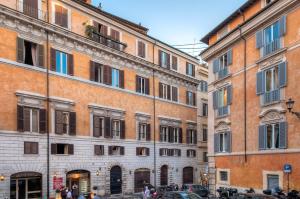 a group of buildings in a street with cars at Fabuloucity Fontana di Trevi in Rome