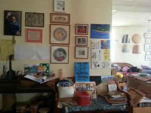 a cluttered living room with many items on the wall at Kunyit 7 Lodge in Bandar Seri Begawan