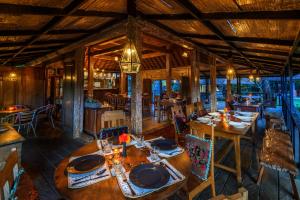 a dining room with wooden tables and chairs at Taman Nauli Boutique Rooms in Canggu
