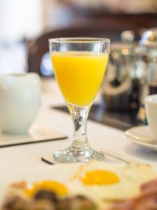 a glass of orange juice sitting on top of a table at Six Brunton Place in Edinburgh