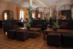 une salle d'attente avec des canapés, des tables et des plantes dans l'établissement Le Clos De L'aube Rouge - Montpellier / Castelnau le Lez, à Castelnau-le-Lez