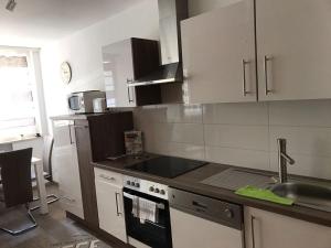 a kitchen with a sink and a stove top oven at City Apartment in Augsburg
