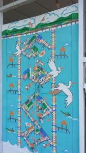 a painting of a beach with seagulls at Kunyit 7 Lodge in Bandar Seri Begawan