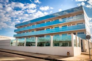 a building with a dog standing in front of it at Executivo Flat II in Parauapebas