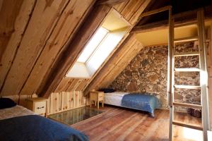 a attic bedroom with a bed and a window at Nuustaku Rancho in Otepää