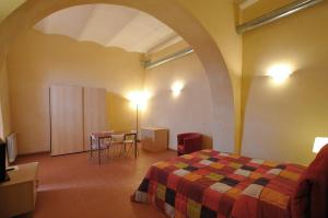 a bedroom with a bed and a table in a room at Terre Regionali Toscane in Alberese +49 photos