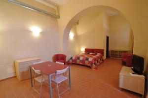 a hotel room with a bed and a table and chairs at Terre Regionali Toscane in Alberese